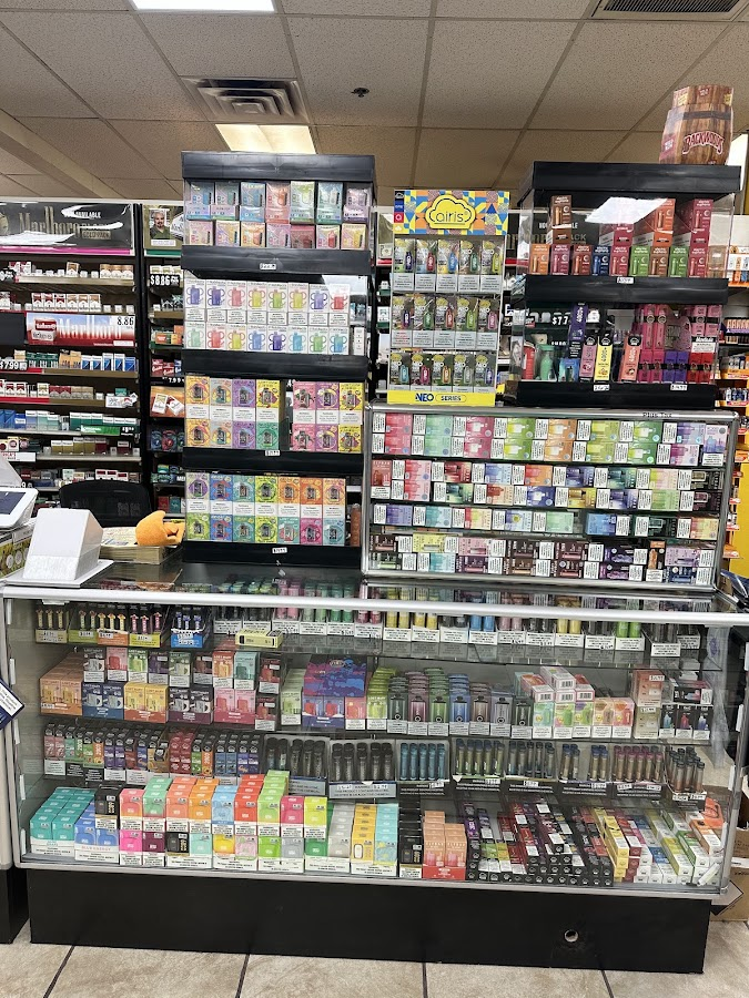 Colorful wall of disposable vapes and e-cigarettes at Discount Cigarettes +