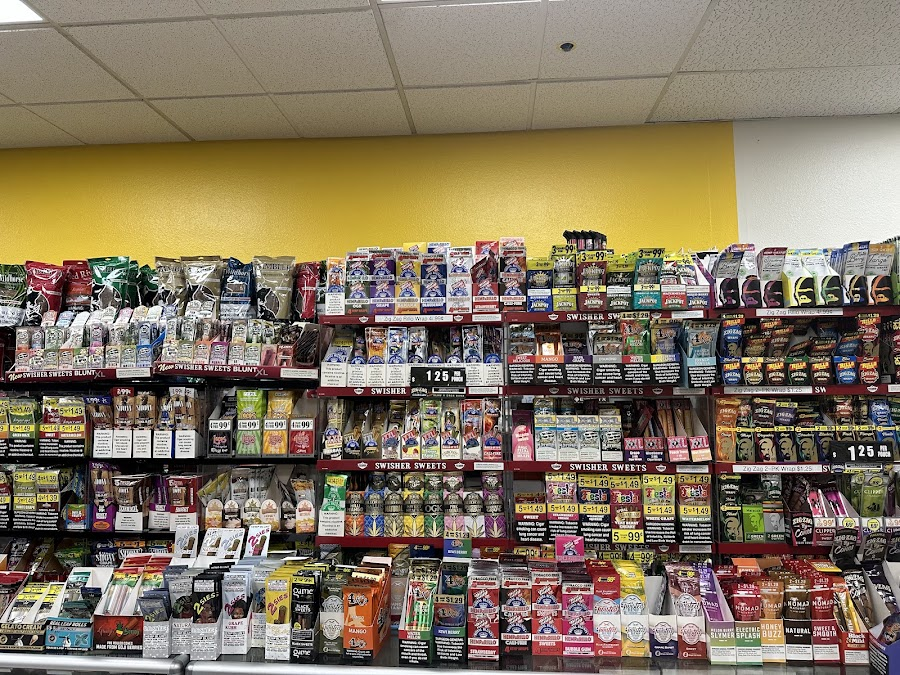 Interior of Discount Cigarettes + showing wall of cigars, wraps, and Swisher Sweets
